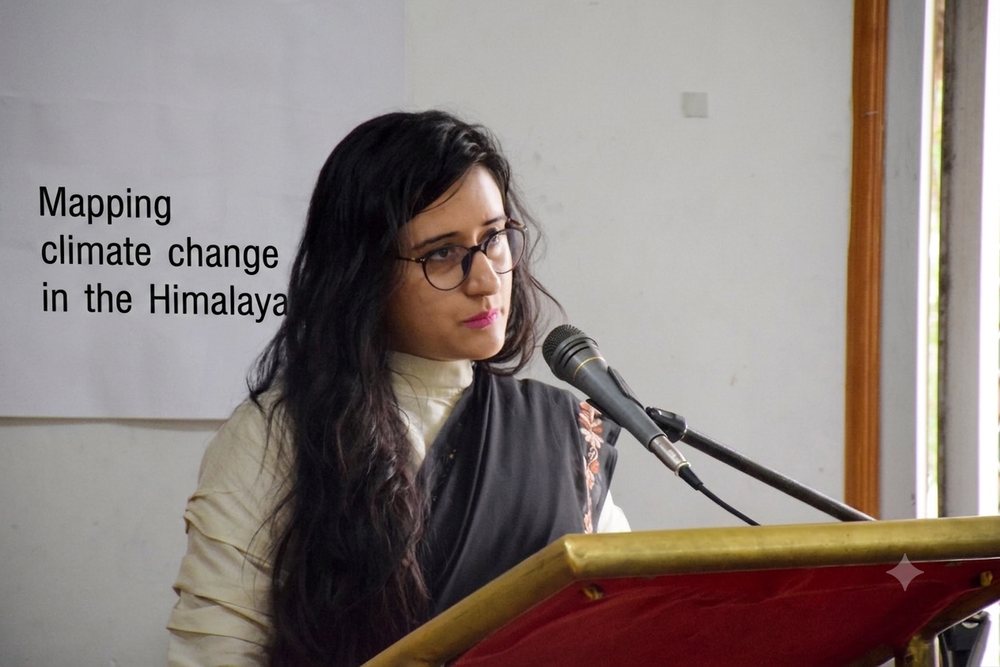 Preksha Sharma presenting "Mapping climate change in the Himalayas" at a podium